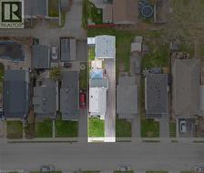 Property outline featuring a main residence with a gray shingle roof, a paved driveway, and a partially grassed front yard - 