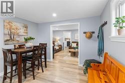 Light wood-finish flooring extends through an open doorway into an additional room - 