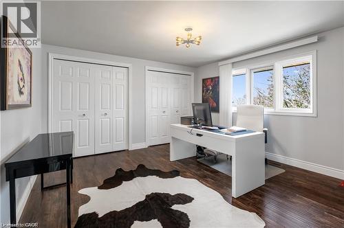 Interior room featuring dark wood-finish flooring, light grey painted walls, and white trim - 355 Edgehill Drive, Kitchener, ON 