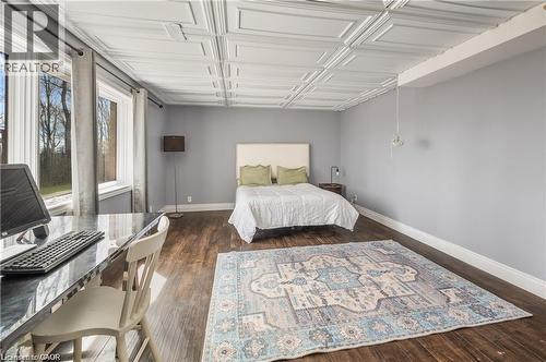 Spacious room featuring wood-finish flooring, a white paneled ceiling, and light gray painted walls - 355 Edgehill Drive, Kitchener, ON 