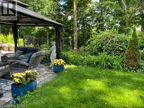 Patio featuring a metal gazebo structure, paver stone hardscaping, and lush perimeter landscaping - 355 Edgehill Drive, Kitchener, ON 
