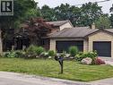 Two-story brick exterior featuring a covered entryway with columns, a prominent Japanese Maple, and a manicured lawn - 355 Edgehill Drive, Kitchener, ON 