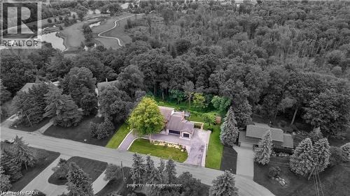 Aerial view showcasing a property with a verdant lawn, mature trees, and an asphalt driveway - 355 Edgehill Drive, Kitchener, ON 