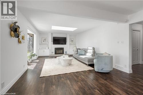 Spacious living area featuring dark wood-finish flooring and white walls - 355 Edgehill Drive, Kitchener, ON 