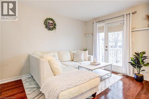 Hardwood-finish flooring complementing light-toned walls - 7 Sirente Drive Unit# 11, Hamilton, ON - Indoor