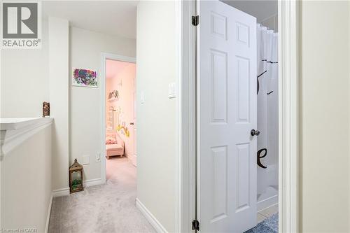Hallway featuring light gray carpeting and white trim - 7 Sirente Drive Unit# 11, Hamilton, ON - Indoor Photo Showing Other Room
