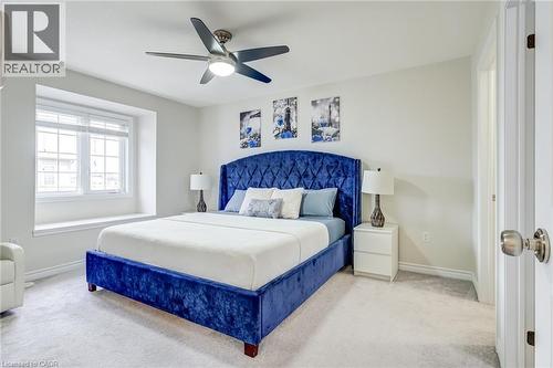Bedroom featuring a window seat, light-toned carpeting, a ceiling fan with integrated lighting, and a white interior door - 7 Sirente Drive Unit# 11, Hamilton, ON - Indoor Photo Showing Bedroom