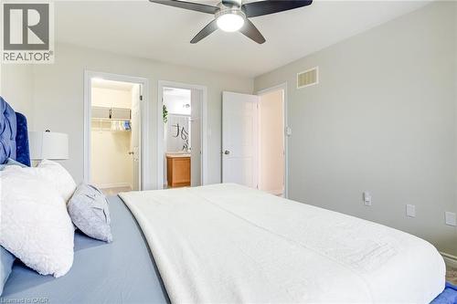 Bedroom featuring light gray walls, a ceiling fan with integrated lighting, and carpet flooring - 7 Sirente Drive Unit# 11, Hamilton, ON - Indoor Photo Showing Bedroom