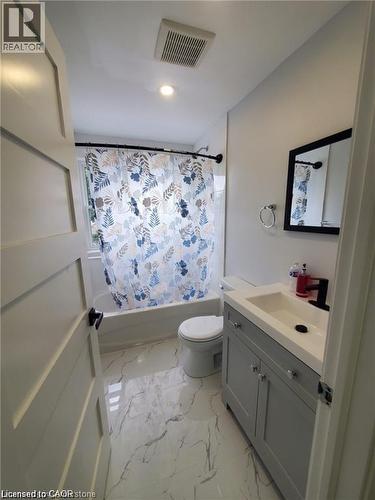 Bathroom featuring a white bathtub, a toilet, and a vanity with a white countertop - 94 Brook Street, Simcoe, ON - Indoor Photo Showing Bathroom