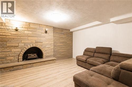 Stone fireplace with arched firebox and hearth - 404 Queenston Road, Hamilton, ON 