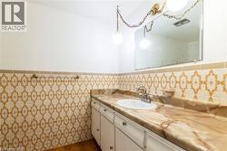 Bathroom vanity with an integrated sink, a polished chrome faucet, and a patterned stone-look countertop - 