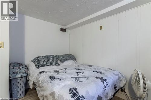 Room with white paneled walls and a textured ceiling - 404 Queenston Road, Hamilton, ON 