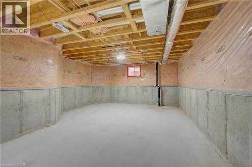 Spacious unfinished basement featuring concrete walls and exposed wood joists - 180 Arthur Fach Drive, Cambridge, ON 