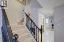 Carpeted staircase featuring dark wood newel posts and balusters - 53 Prosperity Drive, Kitchener, ON 