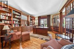 Wood-finish flooring throughout, complemented by extensive built-in cabinetry and shelving - 