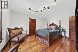 Hardwood flooring, crown molding, and wainscoting enhance this room - 