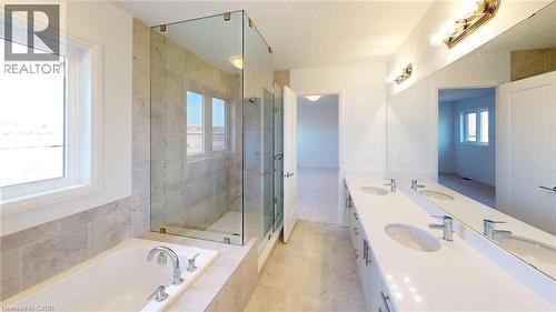 Contemporary bathroom featuring a spacious walk-in shower with glass enclosure, a built-in soaking tub, a dual vanity with undermount sinks, and large format tile flooring - 200 Cittadella Boulevard, Hamilton, ON 