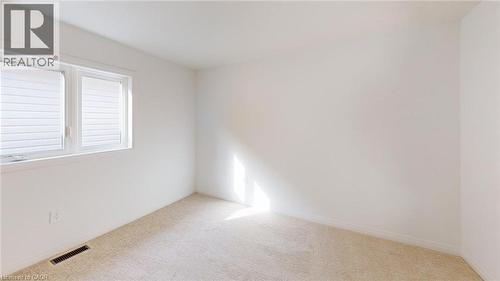 Room featuring light-toned carpeting, white walls, and a window with white blinds - 200 Cittadella Boulevard, Hamilton, ON 
