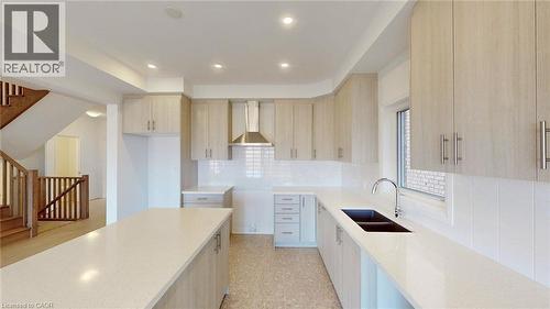 Modern kitchen featuring light wood-finish cabinetry, white countertops, and a subway tile backsplash - 200 Cittadella Boulevard, Hamilton, ON 
