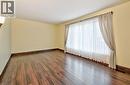 Room with wood-finish flooring, light yellow walls, and dark wood baseboards - 1476 Barton Street E Unit# 2, Hamilton, ON 