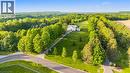 Expansive property featuring a white two-story residence, a long paved driveway, and mature landscaping - 6195 Milburough Line, Burlington, ON 