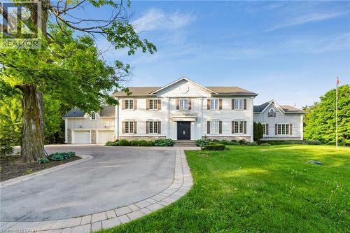Colonial-style residence featuring white siding and dark shutters - 6195 Milburough Line, Burlington, ON - Outdoor With Facade