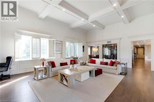 Spacious living area featuring a coffered ceiling, recessed lighting, and wood-finish flooring - 6195 Milburough Line, Burlington, ON - Indoor Photo Showing Living Room