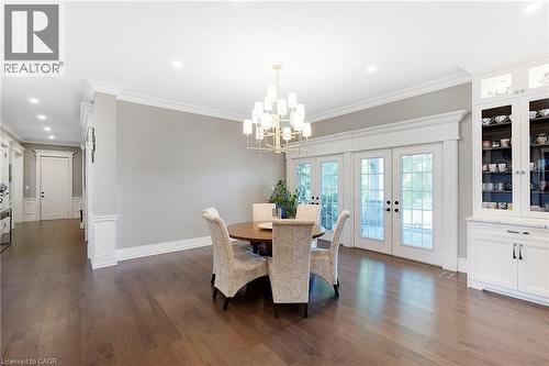Hardwood flooring throughout featuring a brass-tone chandelier - 6195 Milburough Line, Burlington, ON - Indoor Photo Showing Dining Room