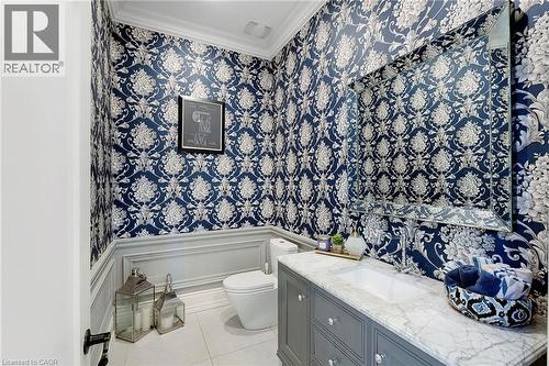 Powder room featuring striking blue and white patterned wallpaper with wainscoting trim - 6195 Milburough Line, Burlington, ON - Indoor Photo Showing Bathroom