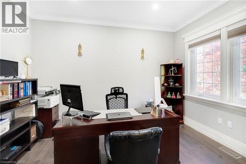 Spacious room featuring wood-finish flooring, white crown molding, and large windows with white trim - 6195 Milburough Line, Burlington, ON - Indoor Photo Showing Office