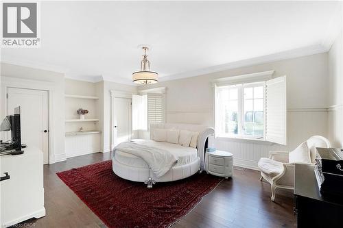 Hardwood-finish flooring complementing light-toned walls and crown molding - 6195 Milburough Line, Burlington, ON - Indoor Photo Showing Bedroom