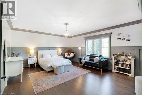 Spacious room featuring wood-finish flooring, wainscoting, and large picture windows - 6195 Milburough Line, Burlington, ON - Indoor Photo Showing Bedroom