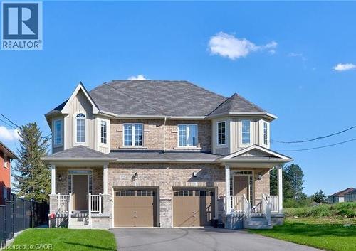 Brick and siding facade with bay windows and individual covered entryways - 154 Rosemount Drive, Kitchener, ON 