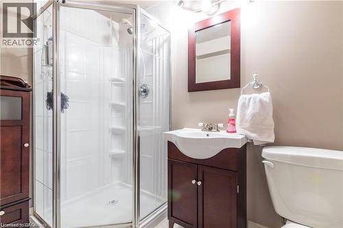 Corner glass shower enclosure with a white shower base and a chrome showerhead - 209 Auburn Drive Unit# A, Waterloo, ON 