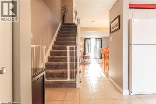 Carpeted staircase with white railings - 209 Auburn Drive Unit# A, Waterloo, ON 