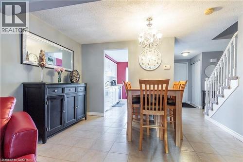 Dining area with tile flooring and a chandelier - 209 Auburn Drive Unit# A, Waterloo, ON 