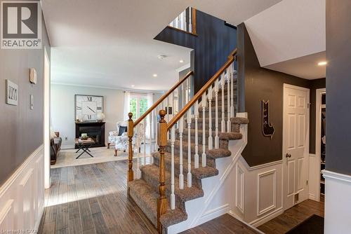 Carpeted staircase with white balusters and wooden handrails - 61 Ditner Avenue, Baden, ON - Indoor Photo Showing Other Room