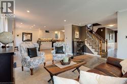 Expansive common area featuring wood-finish flooring, recessed lighting, and crown molding - 