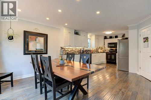 Open-concept dining area featuring wood-finish flooring, recessed lighting, and crown molding - 61 Ditner Avenue, Baden, ON - Indoor Photo Showing Dining Room