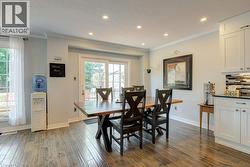 Dining area featuring wood-finish flooring, recessed lighting, and a sliding glass door to the exterior - 