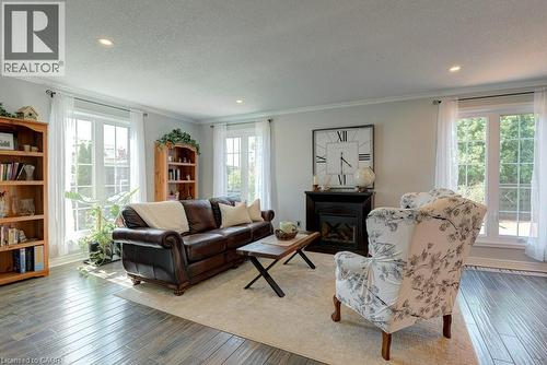 Spacious living area featuring wood-finish flooring, recessed lighting, and crown molding - 61 Ditner Avenue, Baden, ON - Indoor Photo Showing Living Room