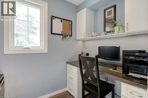 Integrated desk area featuring white cabinetry, under-cabinet lighting, a stone-finish countertop, and wood-finish flooring - 61 Ditner Avenue, Baden, ON - Indoor