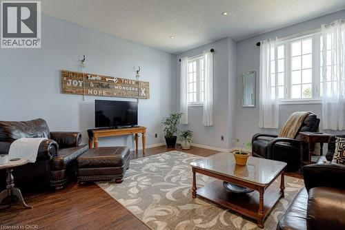 Living area featuring wood-finish flooring, light grey walls, white trim, and recessed lighting - 61 Ditner Avenue, Baden, ON - Indoor Photo Showing Living Room