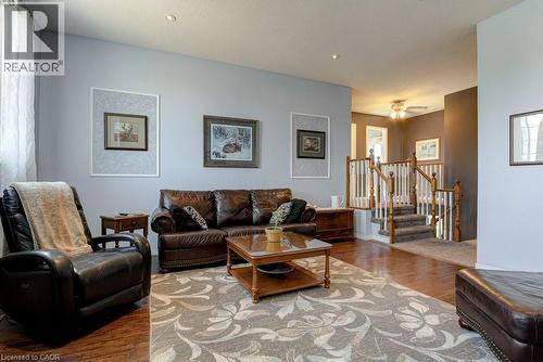Open-concept living space featuring wood-finish flooring, recessed lighting, and a neutral color palette - 61 Ditner Avenue, Baden, ON - Indoor Photo Showing Living Room