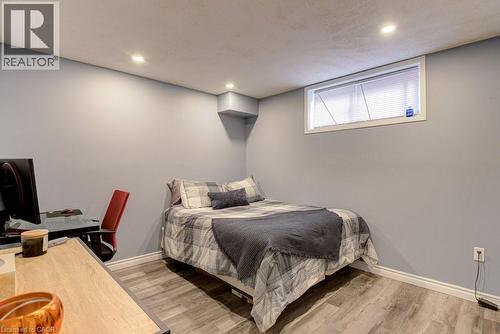 Room featuring light gray walls, recessed ceiling lighting, a single window with blinds, and wood-finish flooring - 61 Ditner Avenue, Baden, ON - Indoor Photo Showing Bedroom