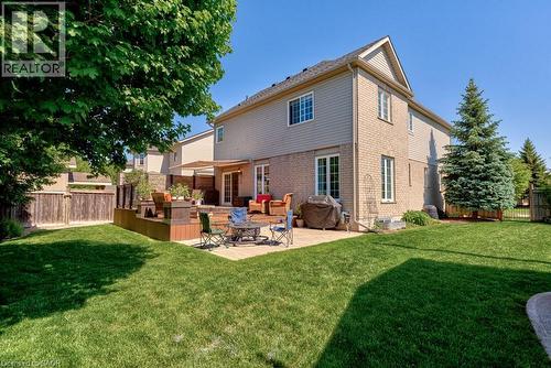 Rear exterior of a two-story residence featuring light-toned brick and siding - 61 Ditner Avenue, Baden, ON - Outdoor With Deck Patio Veranda