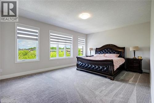 Spacious room with light gray walls and plush gray carpeting - 57 Hollybrook Trail, Kitchener, ON 