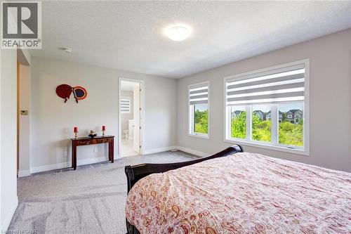 Spacious room featuring multiple windows with integrated blinds, light gray wall paint, and plush carpeting - 57 Hollybrook Trail, Kitchener, ON 