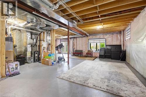 Unfinished basement offering exposed wood joists, structural beams, and concrete flooring - 57 Hollybrook Trail, Kitchener, ON 