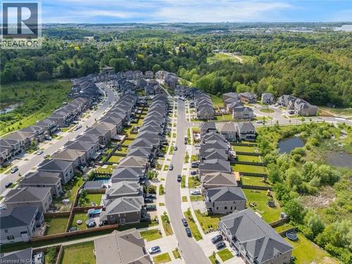 Aerial perspective of a developed residential area featuring rows of detached homes with varied architectural styles and gray pitched roofs - 57 Hollybrook Trail, Kitchener, ON 